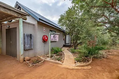 a building with a red fire hydrant in front of it at Wildheart Safari - Lion's Den in Hoedspruit