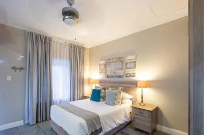 a bedroom with a bed and a window at Stevenski's Guesthouse in Lephalale