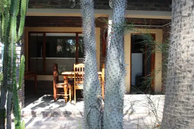 a patio with a table and chairs on a house at Stevenski's Guesthouse in Lephalale