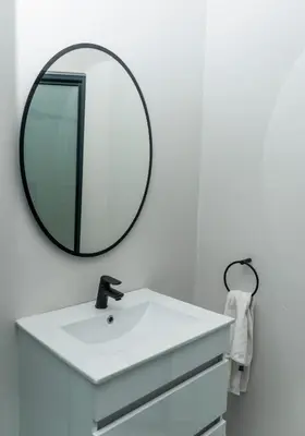 a bathroom with a white sink and a mirror at Waterfall Apartments Waterfall Cres in Midrand