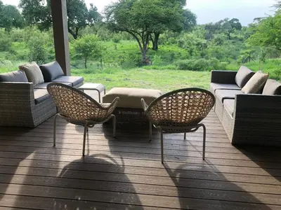a porch with two chairs and a couch and a table at Barn Owl Lodge, Mjejane Game Reserve, Greater Kruger Park in Hectorspruit