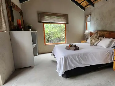 a bedroom with a bed with a teddy bear on it at African Sky Bush Camp in Rabelaisruskamp