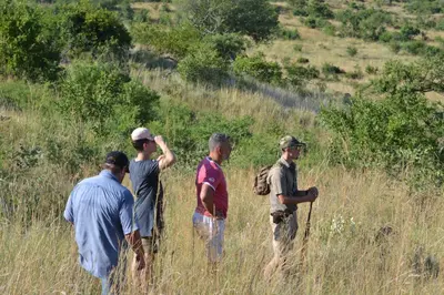 a group of men standing in a field at Balule Bushveld Safari Lodge in Phalaborwa