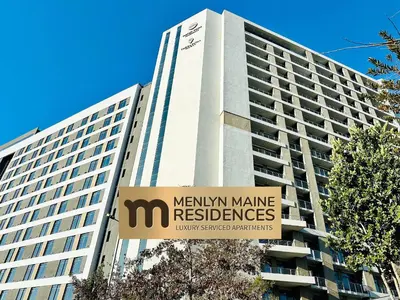 a large building with a sign in front of it at Menlyn Maine Residences - Kyoto king size xl bed in Pretoria