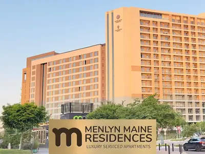 a sign in front of a menskin name residences building at Menlyn Maine Residences - Kyoto king size xl bed in Pretoria