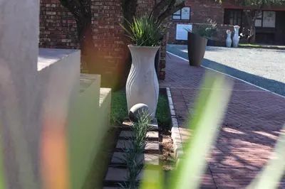 a large white vase sitting on the side of a building at Big D Accommodation & guesthouse in Northam