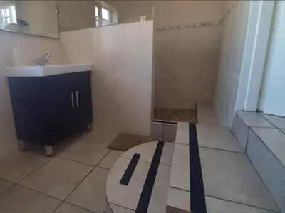 a bathroom with a sink and a mirror and a counter at Kings B&B in Lake Chrissie