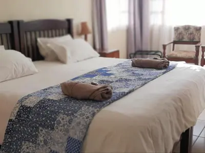 two towels are sitting on top of a bed at Kings B&B in Lake Chrissie