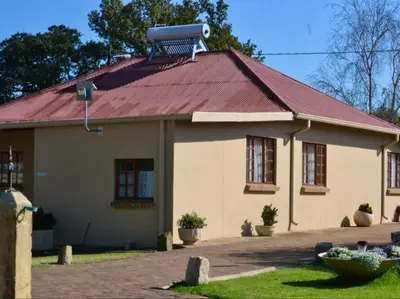 a house with a red roof with a satellite at Kings B&B in Lake Chrissie