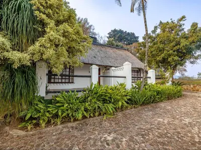 an old white house with a roof at Royal Bakoena Hamiltonparks Country Lodge in Hazyview
