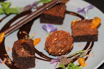 a plate with three pieces of brownies and chocolate at Valley View dullstroom - check in at The Highlander Hotel in Dullstroom