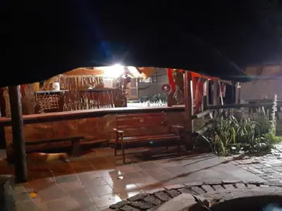 a restaurant with benches and a bar with a light at Hornbill Private Lodge Mabalingwe in Mabula