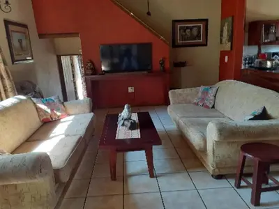 a living room with two couches and a coffee table at Hornbill Private Lodge Mabalingwe in Mabula