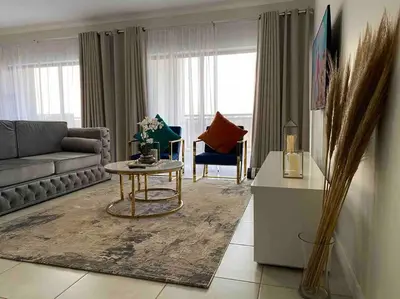 a living room with a couch and a table at Luxury Penthouse Apartment at the Blyde Pretoria in Pretoria