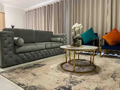 a living room with a couch and a table at Luxury Penthouse Apartment at the Blyde Pretoria in Pretoria