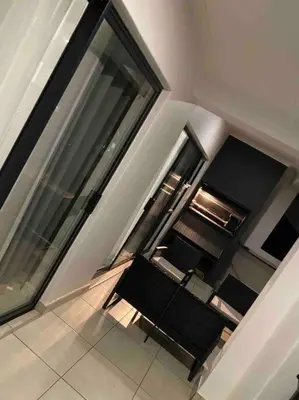 a room with a bench in a building with windows at Luxury Penthouse Apartment at the Blyde Pretoria in Pretoria