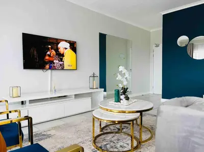 a living room with a couch and a table at Luxury Penthouse Apartment at the Blyde Pretoria in Pretoria