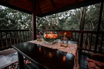 a table on a screened in porch with a candle at Thulamela Couples Retreat in Hazyview