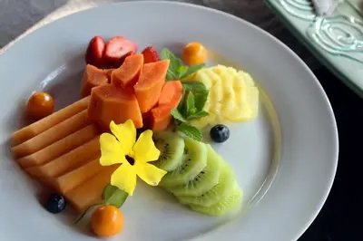 a plate of fruit and vegetables on a table at Thulamela Couples Retreat in Hazyview