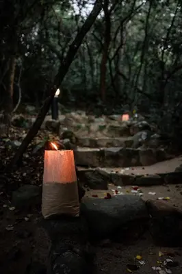 a candle sitting on some rocks in the woods at Thulamela Couples Retreat in Hazyview