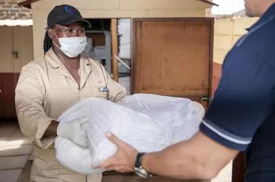 a man wearing a mask holding a piece of cloth at Ecomotel Isando in Kempton Park