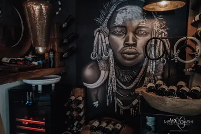 a large painting of a woman on a wall at African Flair Boutique Safari Lodge in Hoedspruit