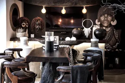 a room with a table and chairs and masks at African Flair Boutique Safari Lodge in Hoedspruit