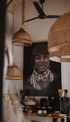 a painting of a black woman on a wall at African Flair Boutique Safari Lodge in Hoedspruit