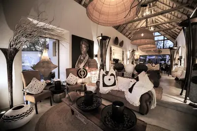 a living room filled with lots of furniture at African Flair Boutique Safari Lodge in Hoedspruit