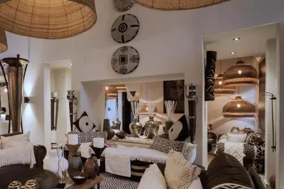 a living room with a couch and a mirror at African Flair Boutique Safari Lodge in Hoedspruit
