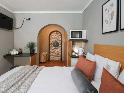 a bedroom with a bed and an arched doorway at 16 Vaalrivier in Secunda