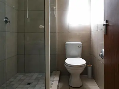 a bathroom with a toilet and a shower at 16 Vaalrivier in Secunda