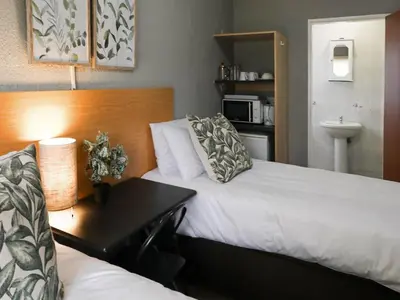 a hotel room with a bed and a desk at 16 Vaalrivier in Secunda