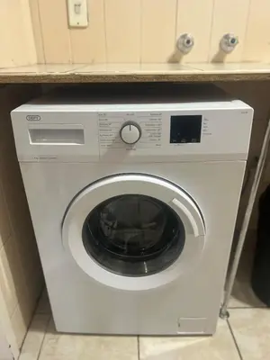 a washing machine in a kitchen with a counter at Menlyn Place Haven in Pretoria