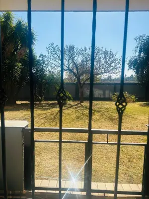 a view of a field from a window at Menlyn Place Haven in Pretoria