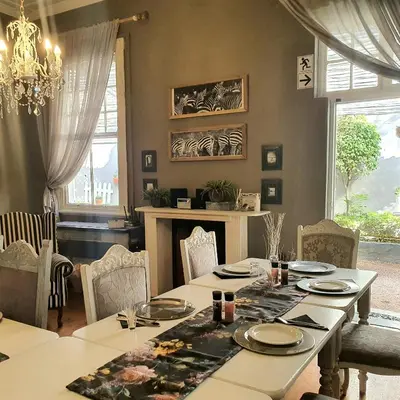 a dining room with a table and chairs at Waterhouse Guest Lodge in Muckleneuk in Pretoria