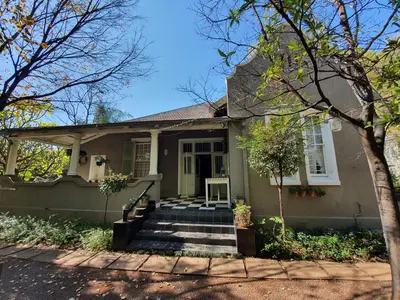 a small house with stairs leading to the front door at Waterhouse Guest Lodge in Muckleneuk in Pretoria