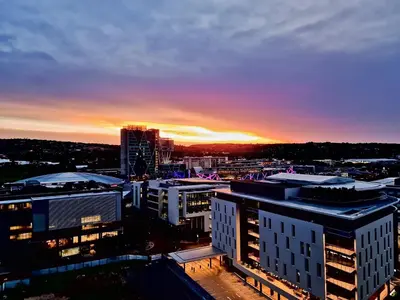 a view of a city at sunset with buildings at Luxurious Menlyn Maine 1 Bedroom on 12th Floor with Stunning Views & No Load Shedding in Pretoria