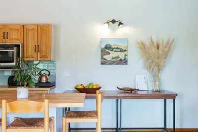 a kitchen with a table with chairs and a counter top at Boekenhout Accommodation in Pretoria