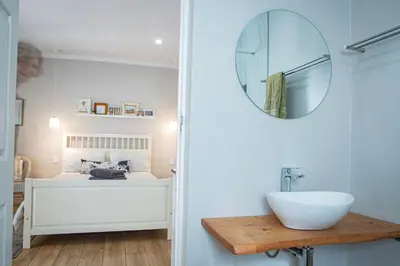 a bathroom with a sink and a mirror at Boekenhout Accommodation in Pretoria