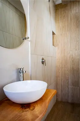 a bathroom with a white sink on a wooden counter at Boekenhout Accommodation in Pretoria