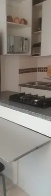 a kitchen with a white counter top with a stove at Bambati residence in Soshanguve