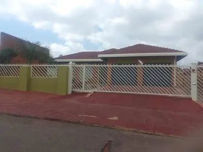 a white fence in front of a house at Bambati residence in Soshanguve