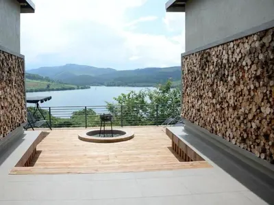 a balcony with a view of a lake at Tshivhase Nature Reserve in Vhutandabos