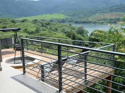 a balcony with a view of a river at Tshivhase Nature Reserve in Vhutandabos