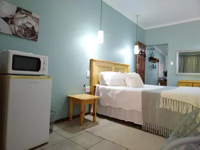 a hotel room with a bed and a tv at Ebenezer Self Catering in Groblersdal