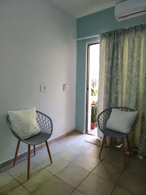 two chairs sitting in a room with a window at Ebenezer Self Catering in Groblersdal