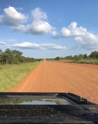 a dirt road in the middle of a field at Tamboti Bush Lodge in Dinokeng Game Reserve