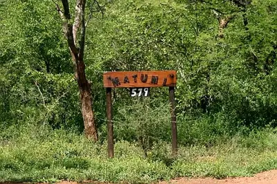 a sign on the side of a dirt road at Matumi Self Catering in Marloth Park