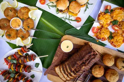 a table with plates of food on a banana leaf at Cape Vulture Lodge in Hoedspruit